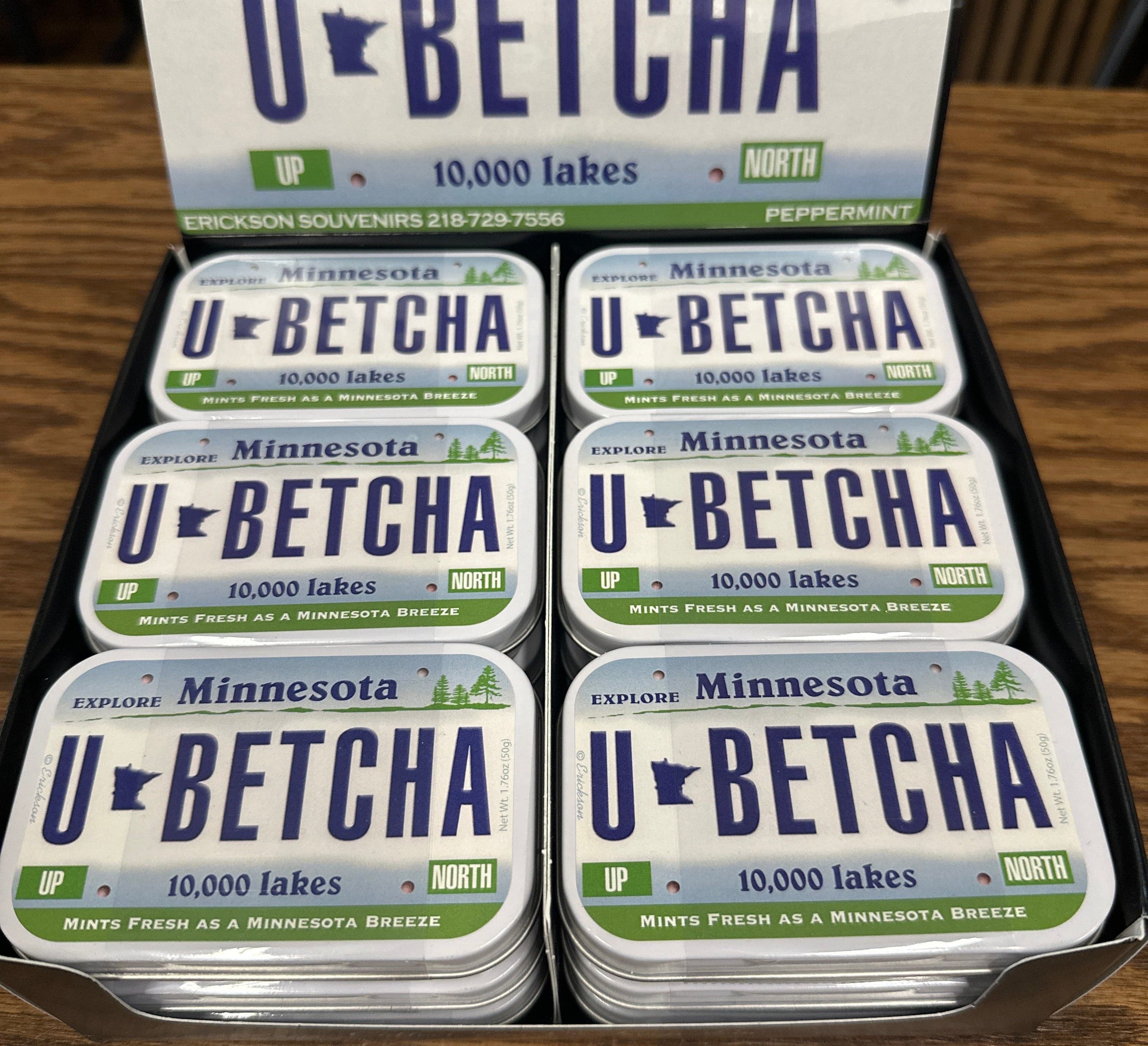 Display of 'U-Betcha' mints with Minnesota-themed packaging on a wooden surface.