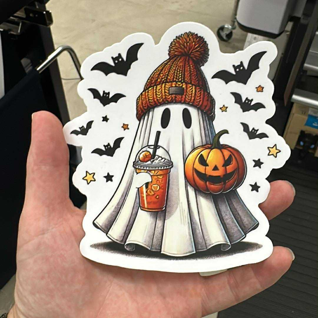 Halloween-themed sticker with a ghost, pumpkin, and cup designed Sticker