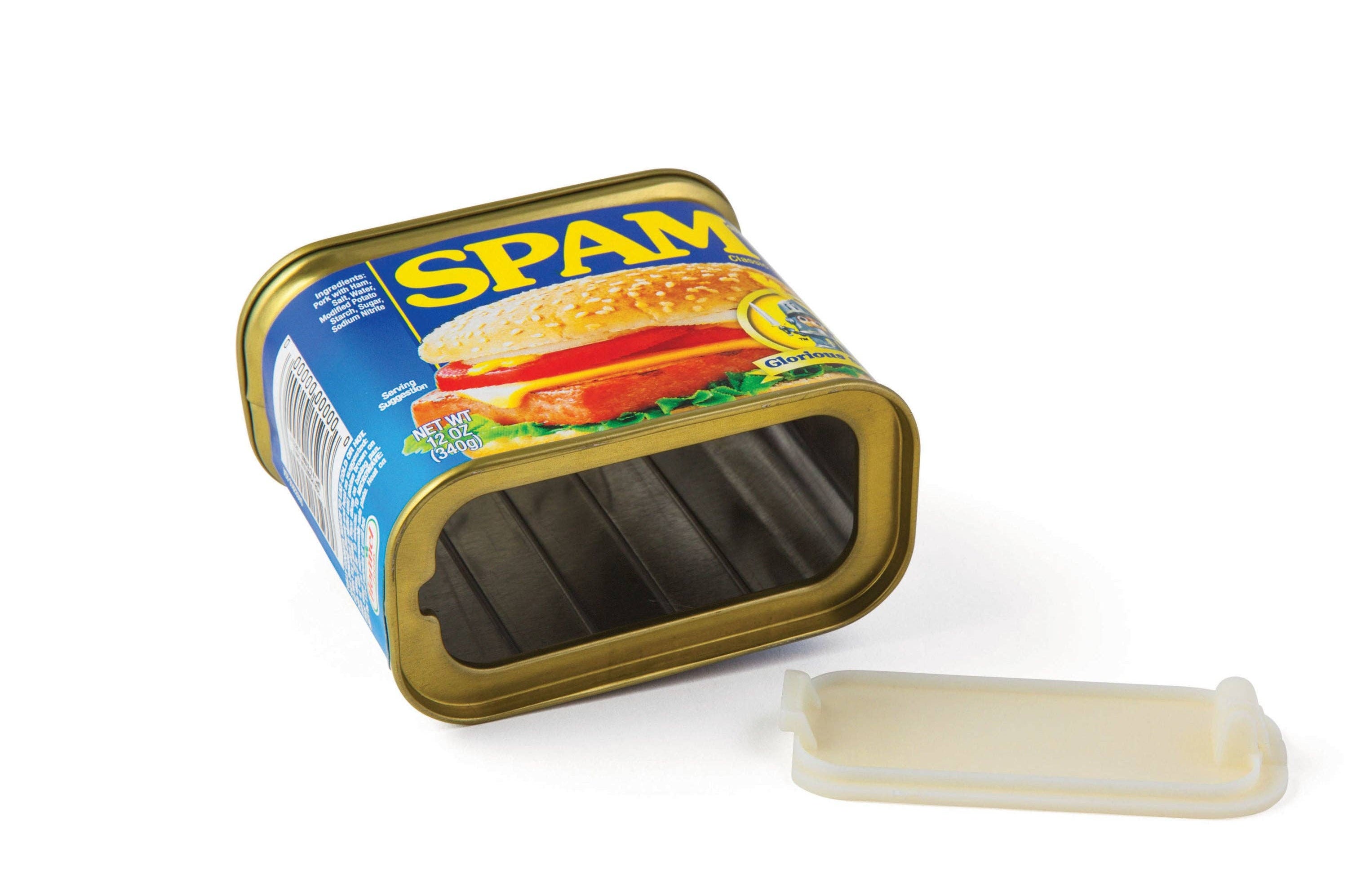 Empty rectangular can of Spam with lid removed, lying on its side. Blue and yellow label featuring a sandwich image, evoking a playful tone.