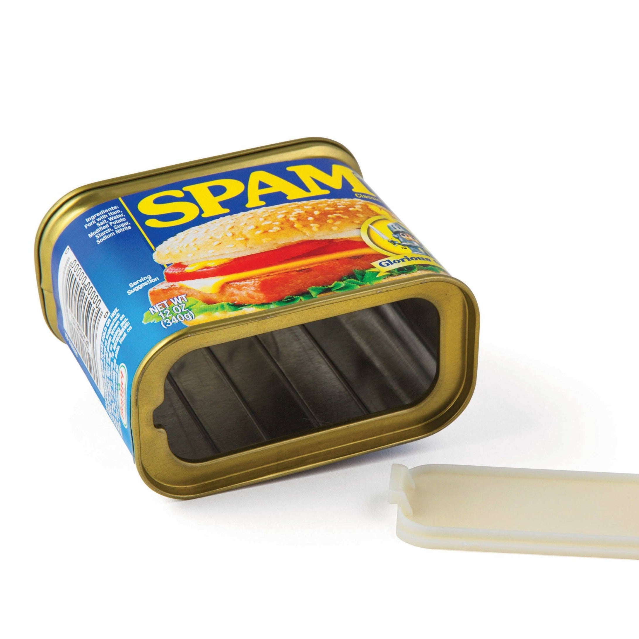 Empty rectangular can of Spam with lid removed, lying on its side. Blue and yellow label featuring a sandwich image, evoking a playful tone.