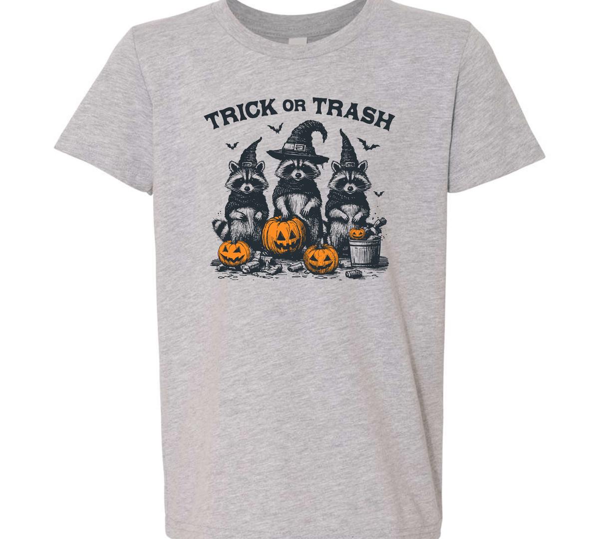 A heather gray short-sleeve t-shirt with a Halloween graphic of three raccoons in witch hats next to jack-o'-lanterns, with the text 'TRICK OR TRASH' above them.