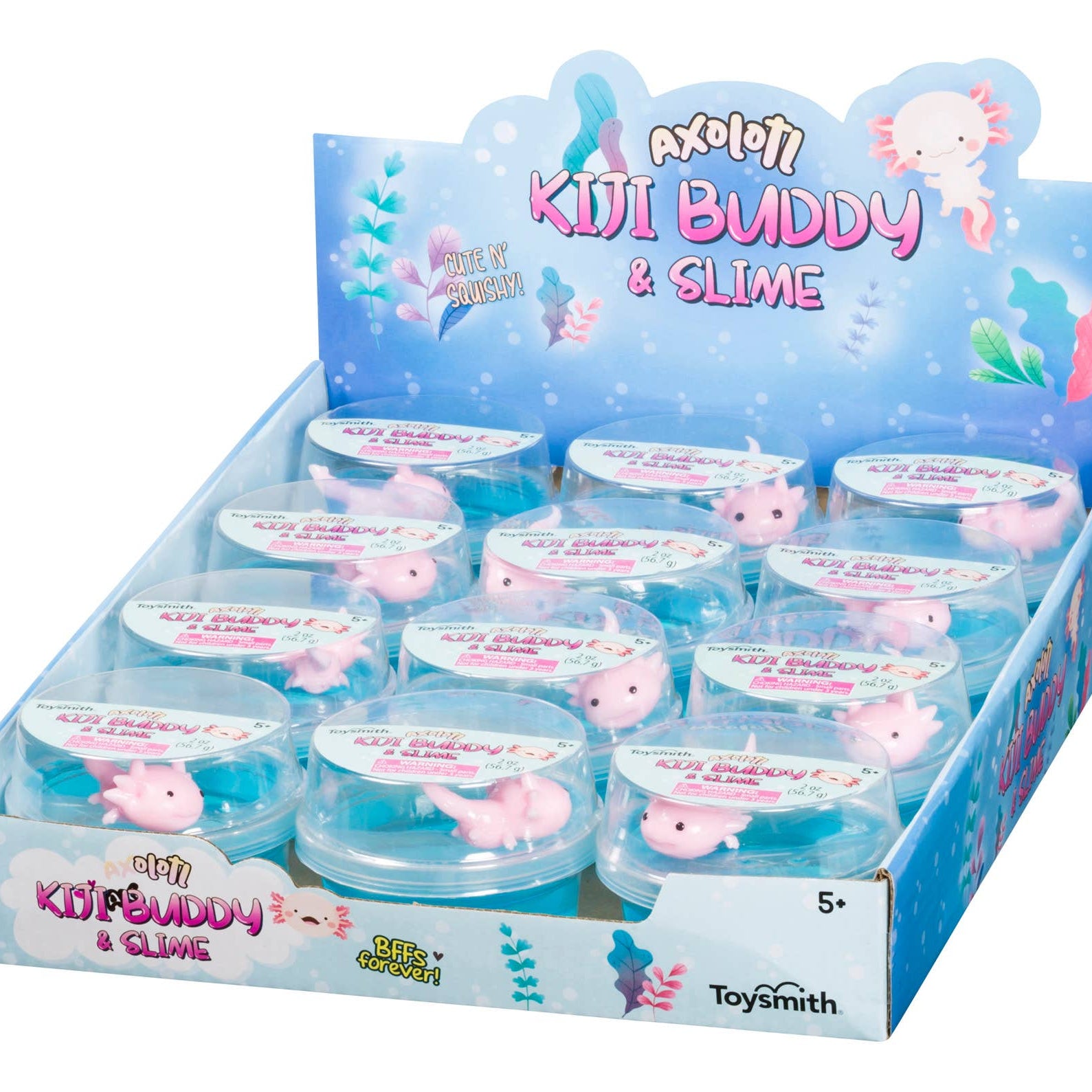 Display of "Axolotl Kiji Buddy & Slime" toys in a blue box. Each container has a cute pink axolotl in clear slime. Packaging is colorful and playful.