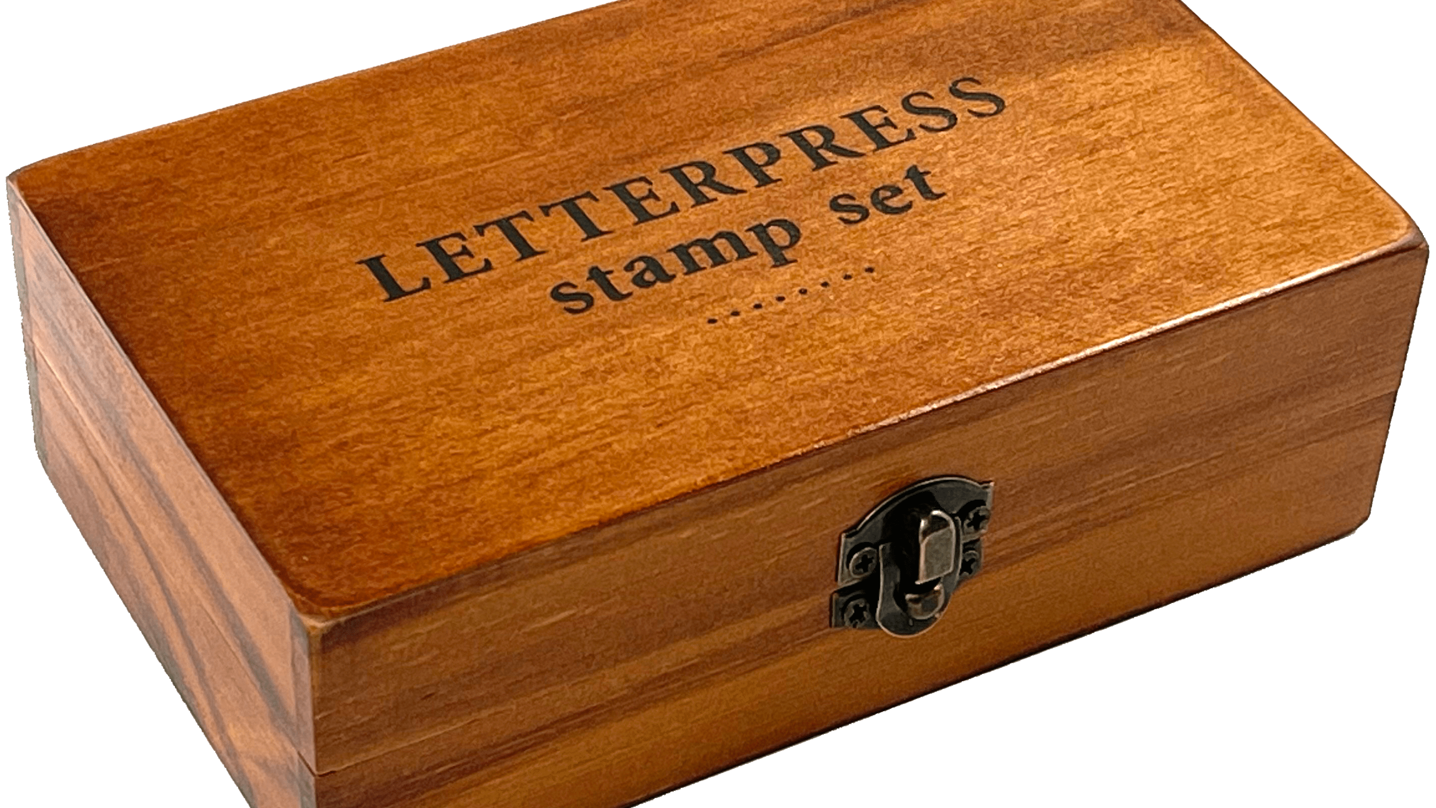 A wooden box labeled "LETTERPRESS stamp set" with a metal latch, resting on a transparent background. The box has a warm, polished finish.