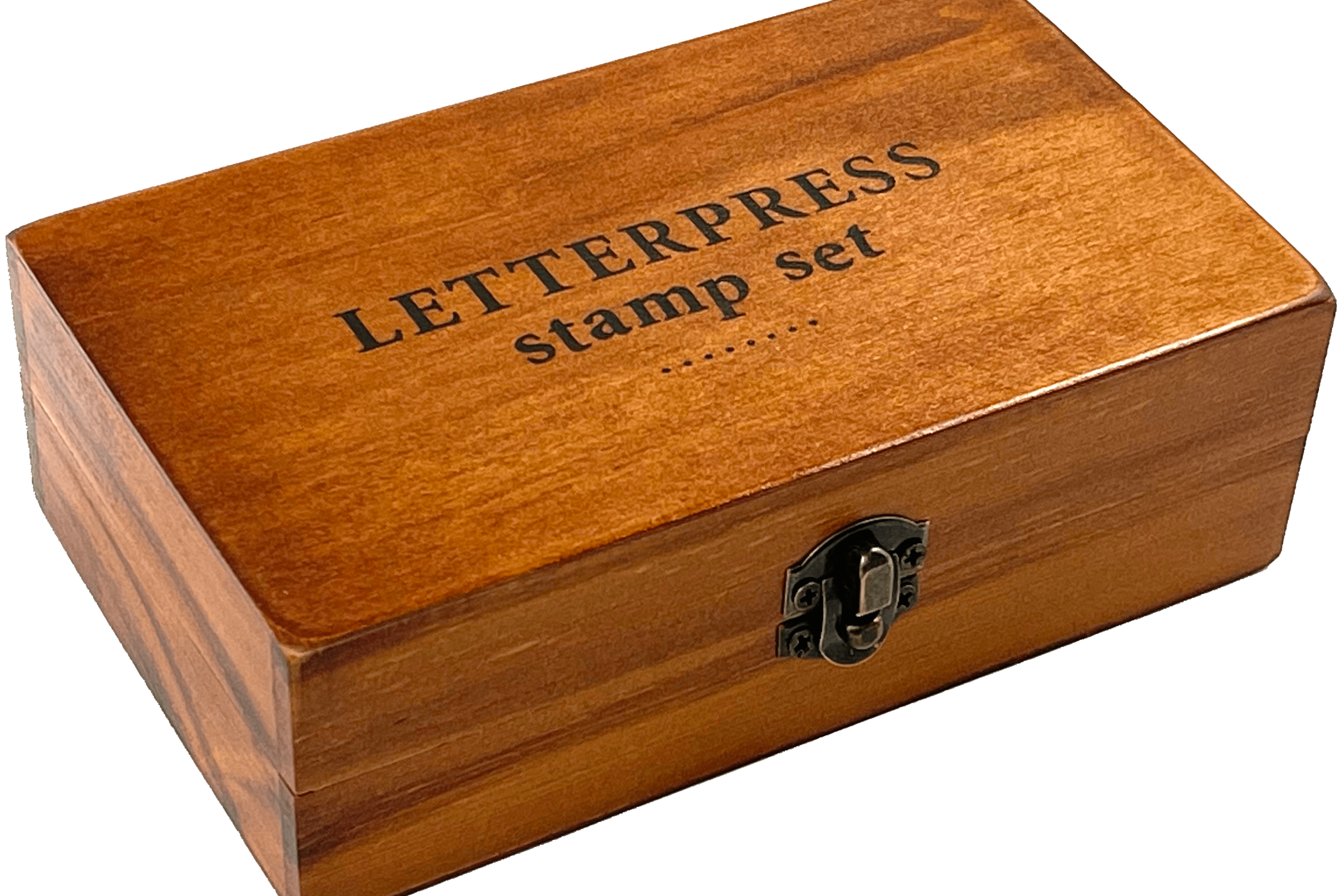 A wooden box labeled "LETTERPRESS stamp set" with a metal latch, resting on a transparent background. The box has a warm, polished finish.