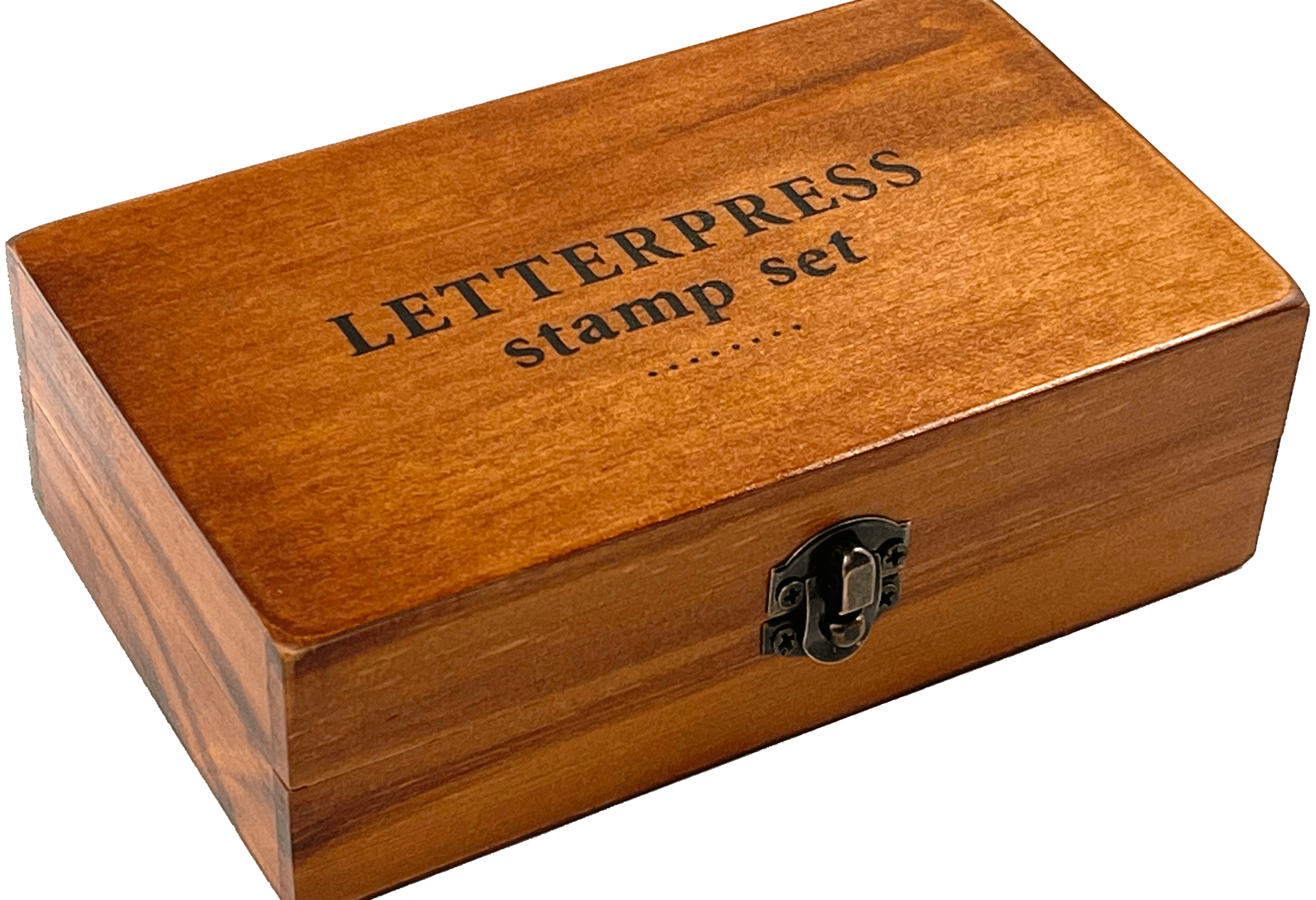 A wooden box labeled "LETTERPRESS stamp set" with a metal latch, resting on a transparent background. The box has a warm, polished finish.