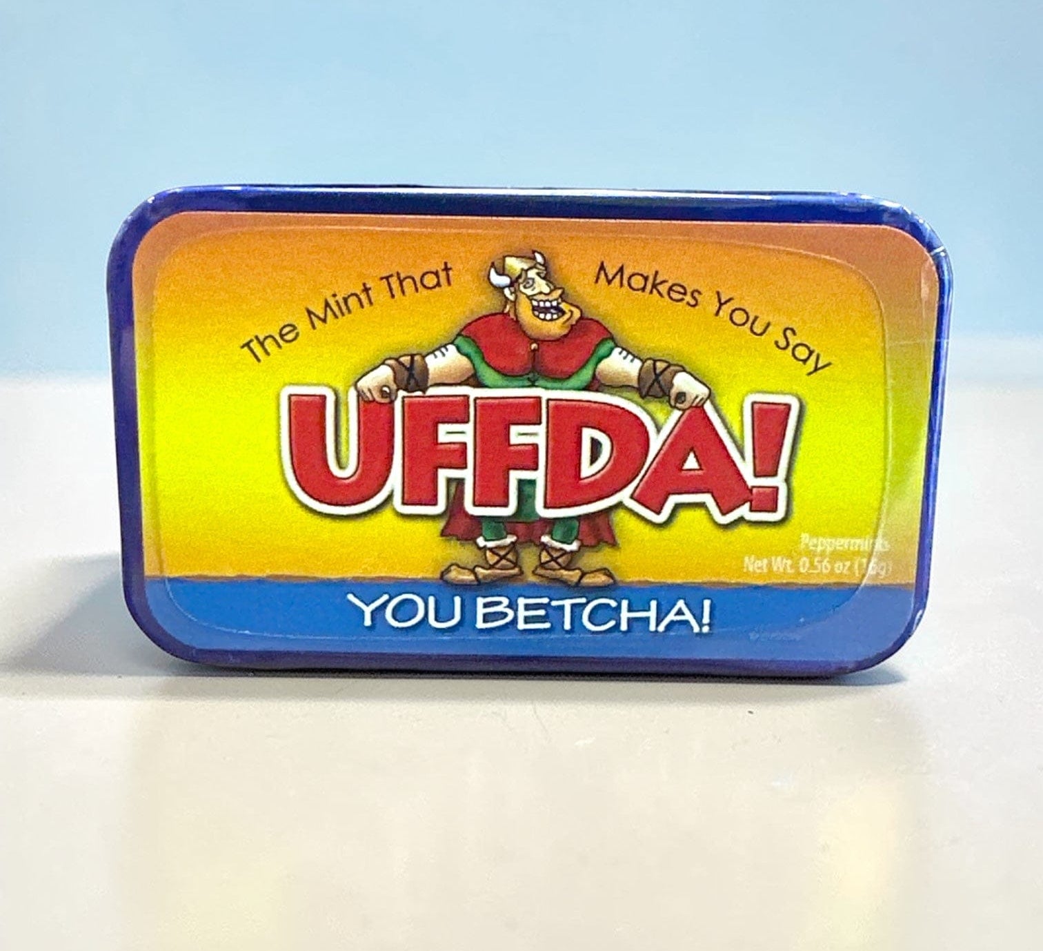 Mint tin with colorful label featuring cartoon character and text “U Betcha!” on a white background
