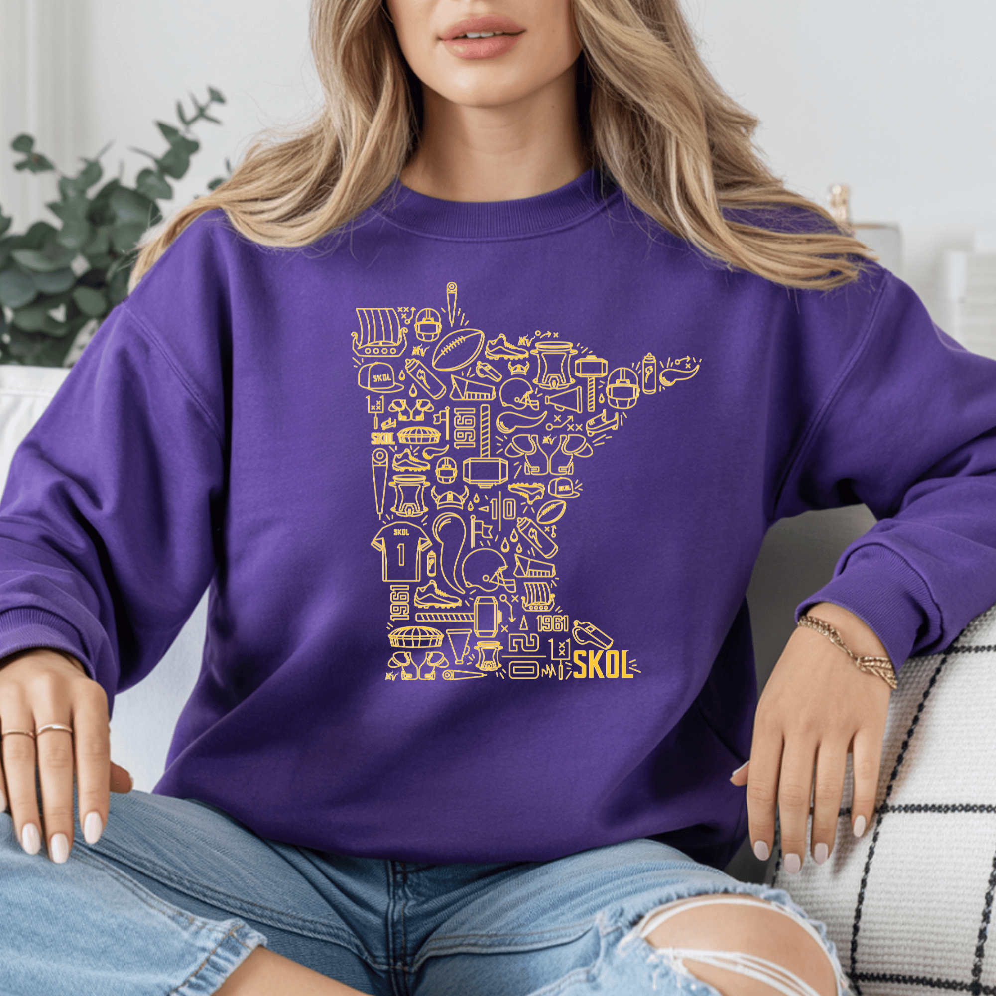 Person wearing a purple sweatshirt with yellow graphic design