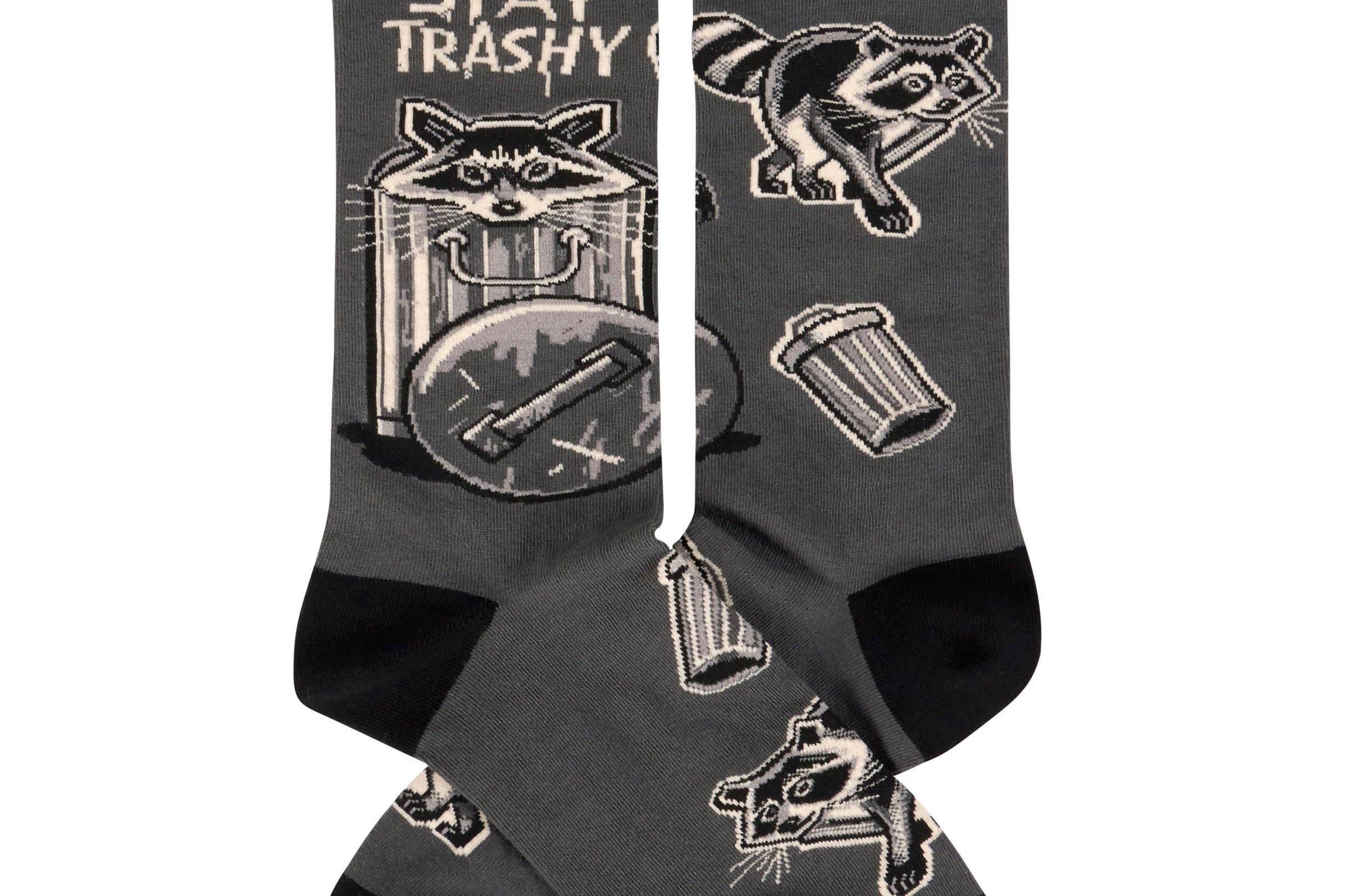 Black socks with raccoon illustrations and 'Stay Trashy' text on a white background