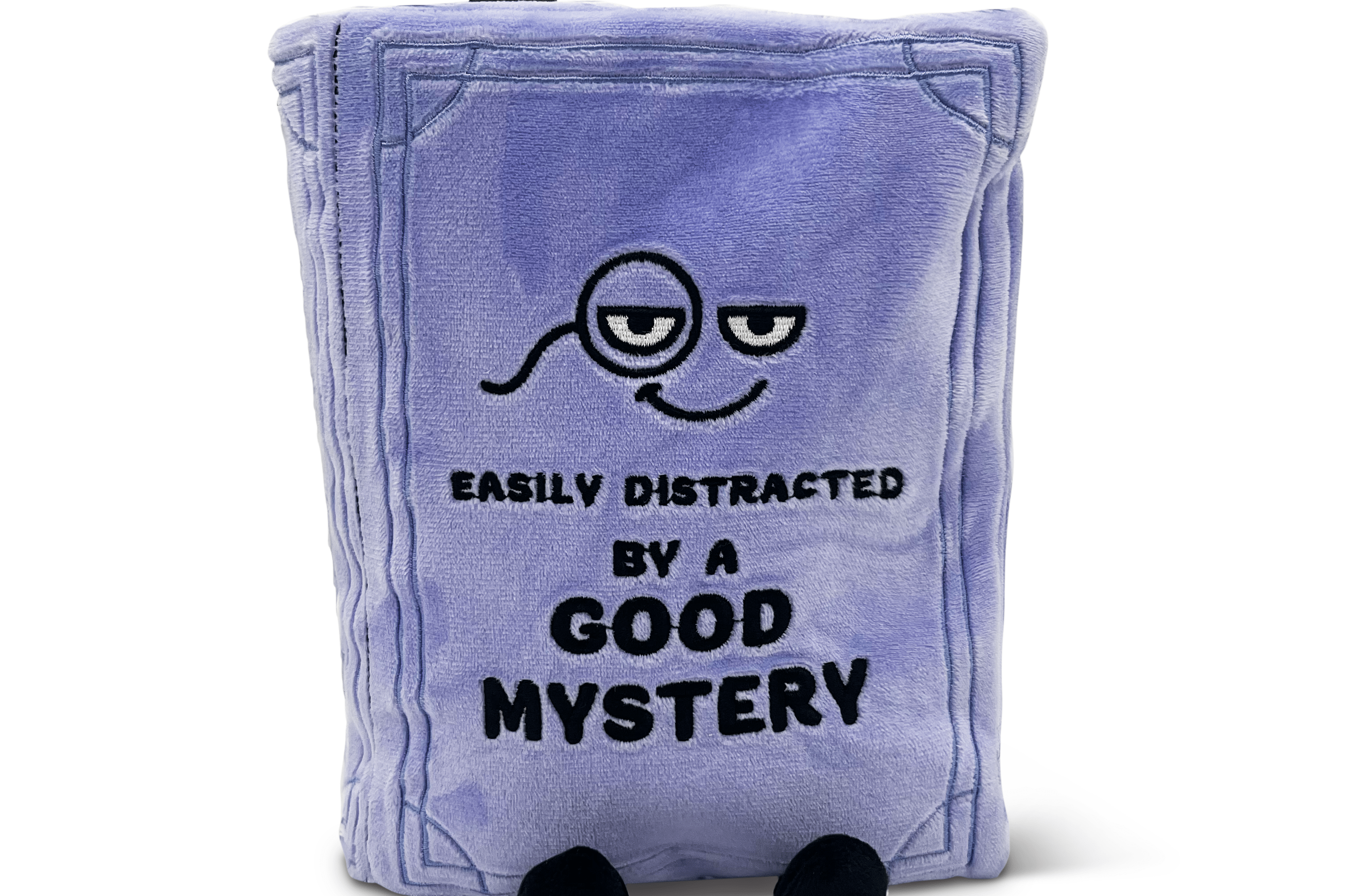 Plush book pillow with a face design and text “easily distracted by a good mystery”