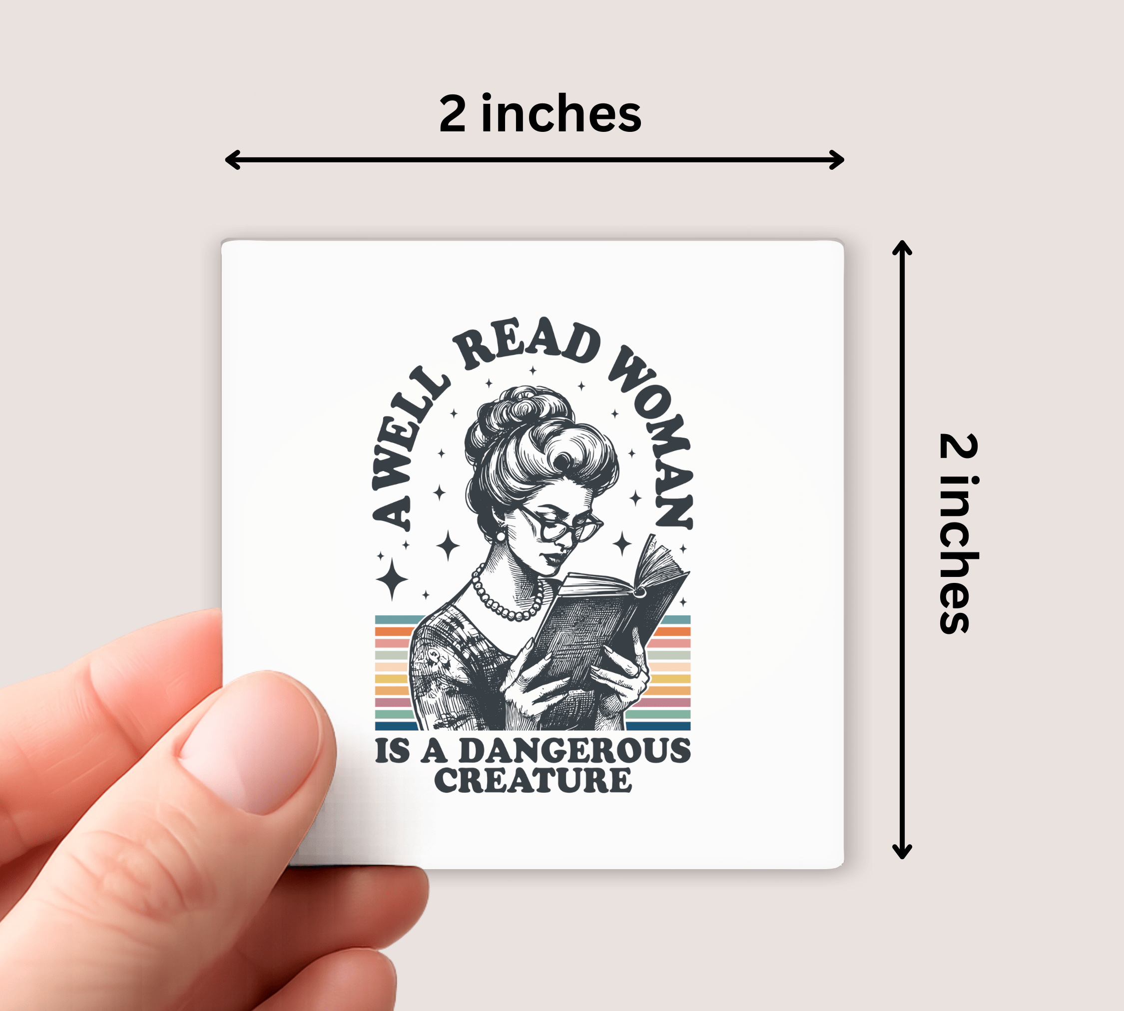 magnet with a design of a woman reading a book and text 'A well-read woman is a dangerous creature' held by a hand, with dimensions indicated.