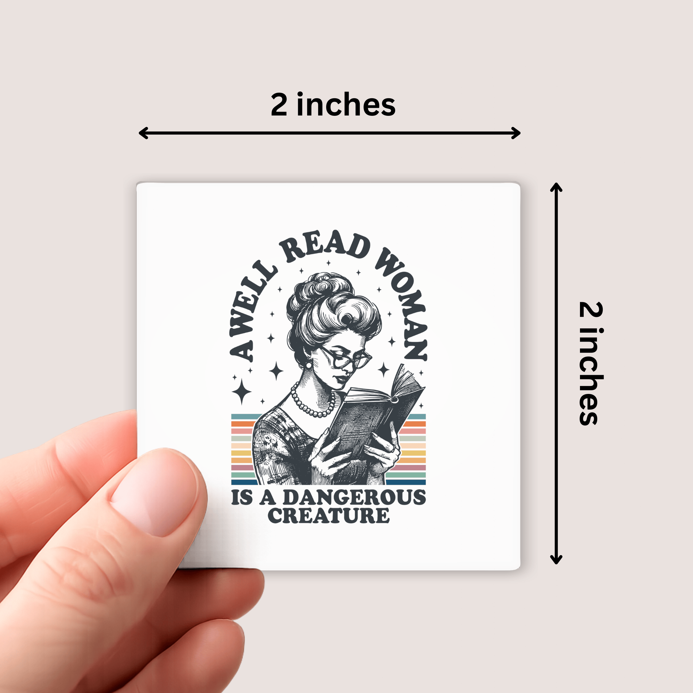 magnet with a design of a woman reading a book and text 'A well-read woman is a dangerous creature' held by a hand, with dimensions indicated.