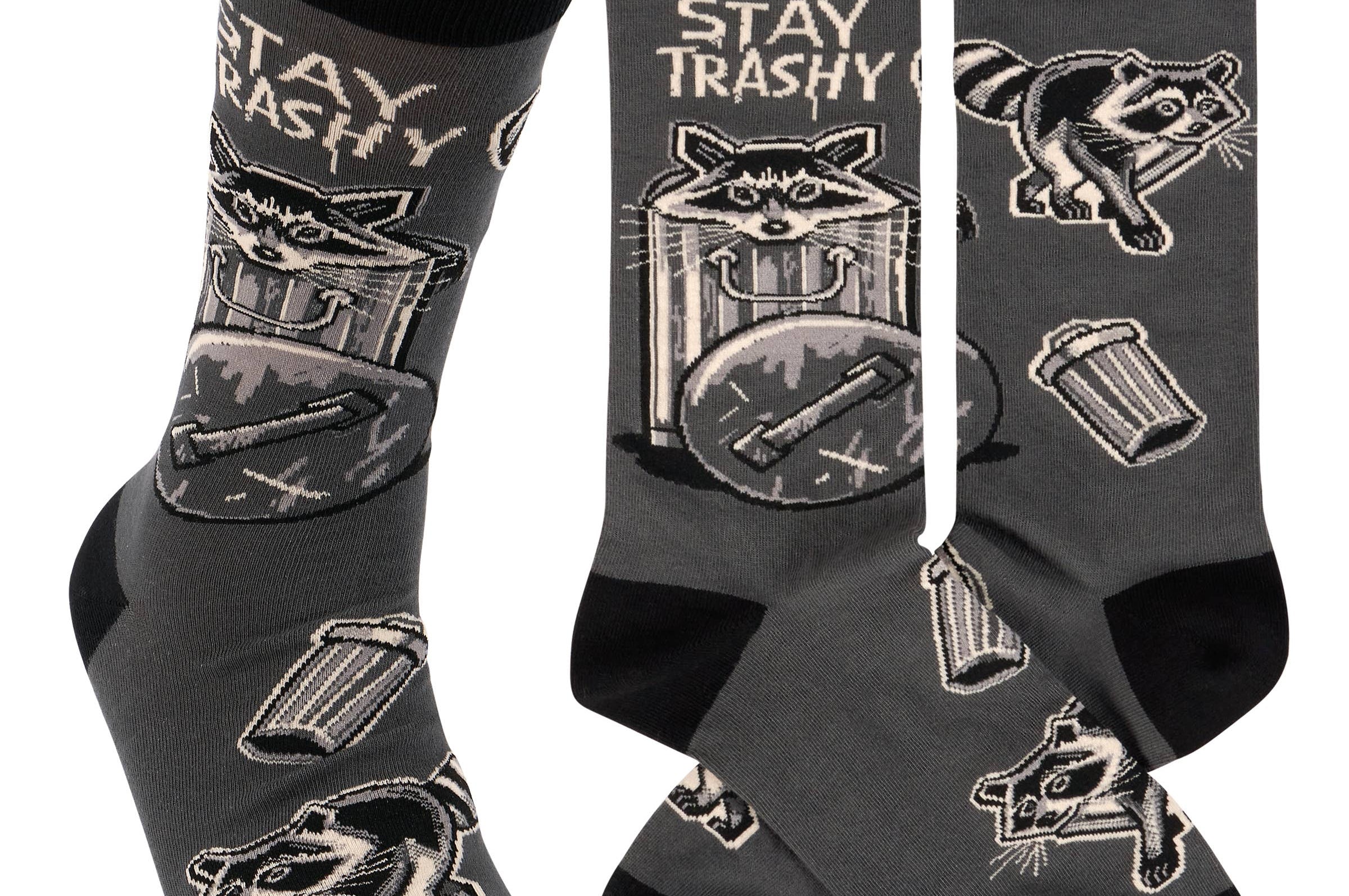 Gray socks with raccoon and trash can designs and 'Stay Trashy' text on a white background