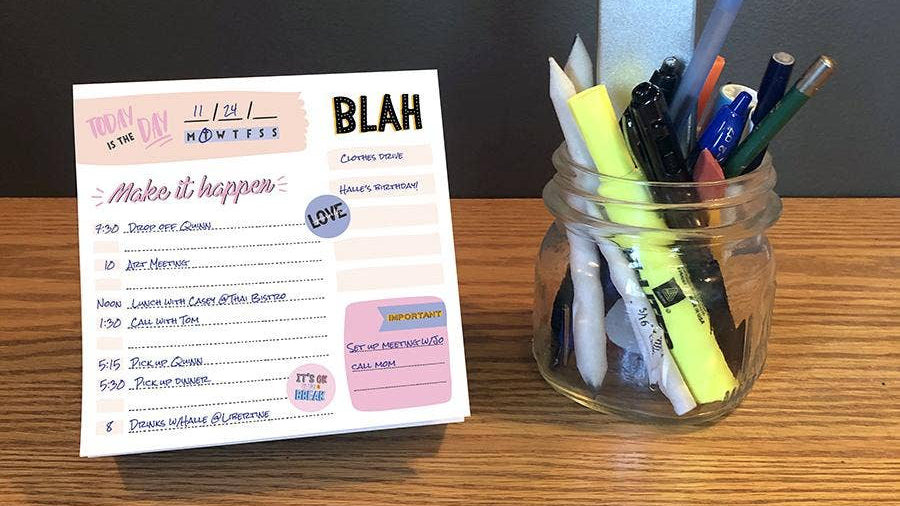 A desk displays a daily planner with a to-do list, titled "Make it happen," alongside a jar filled with markers, pens, and a nail file, conveying organization.