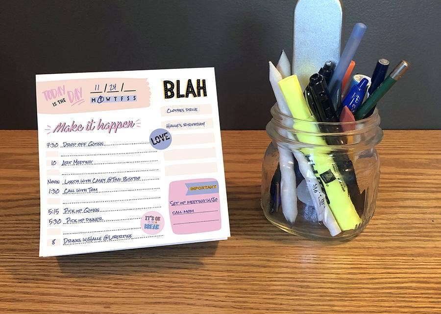 A desk displays a daily planner with a to-do list, titled "Make it happen," alongside a jar filled with markers, pens, and a nail file, conveying organization.