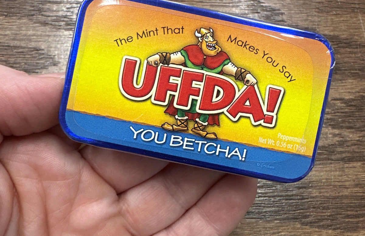 Mint tin with colorful label featuring cartoon character and text “U Betcha!” on a white background