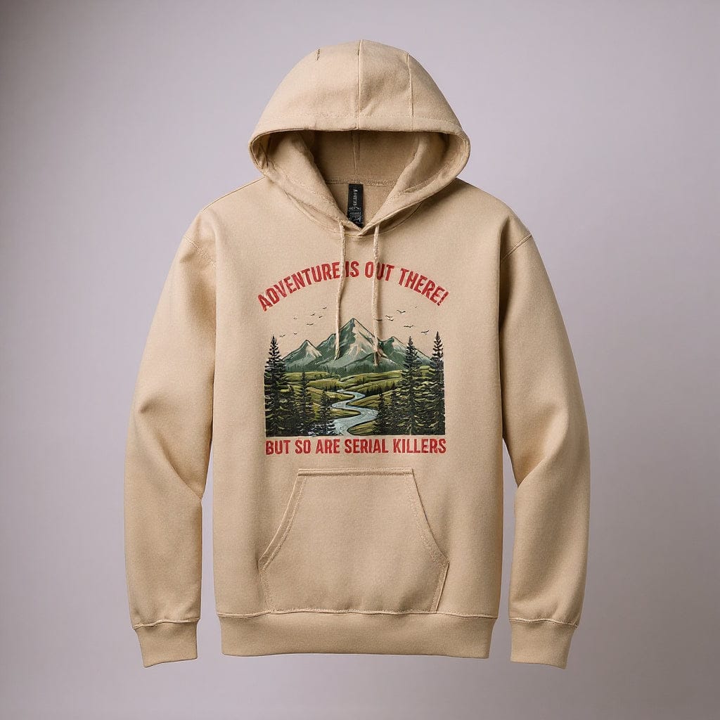 Sand colored hoodie with a graphic design of a mountain and trees, featuring text on a white background. Image reads "Adventure is out there but so are serial killers"