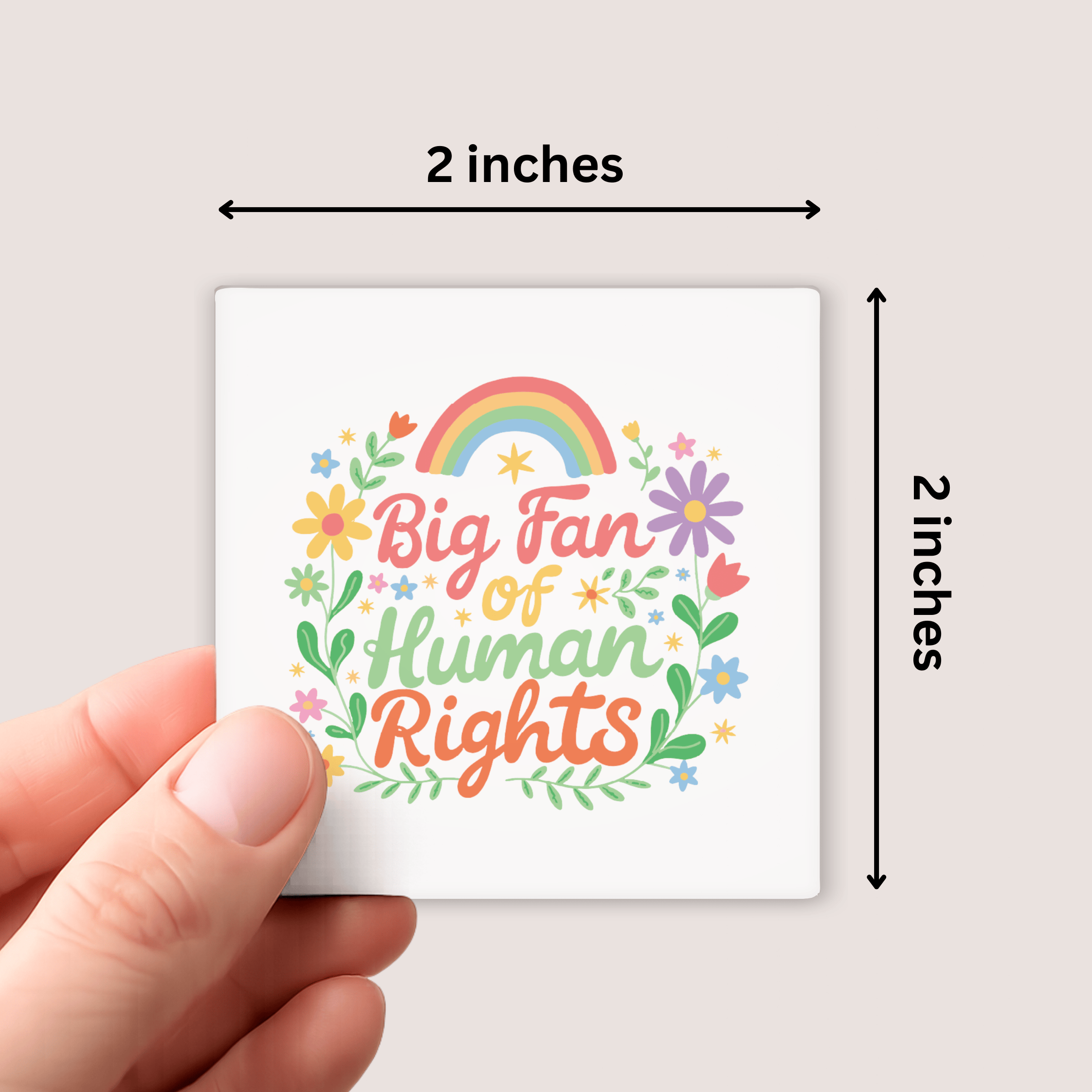 Small square sticker with 'Big Fan of Human Rights' text and rainbow, held by a hand against a light background.