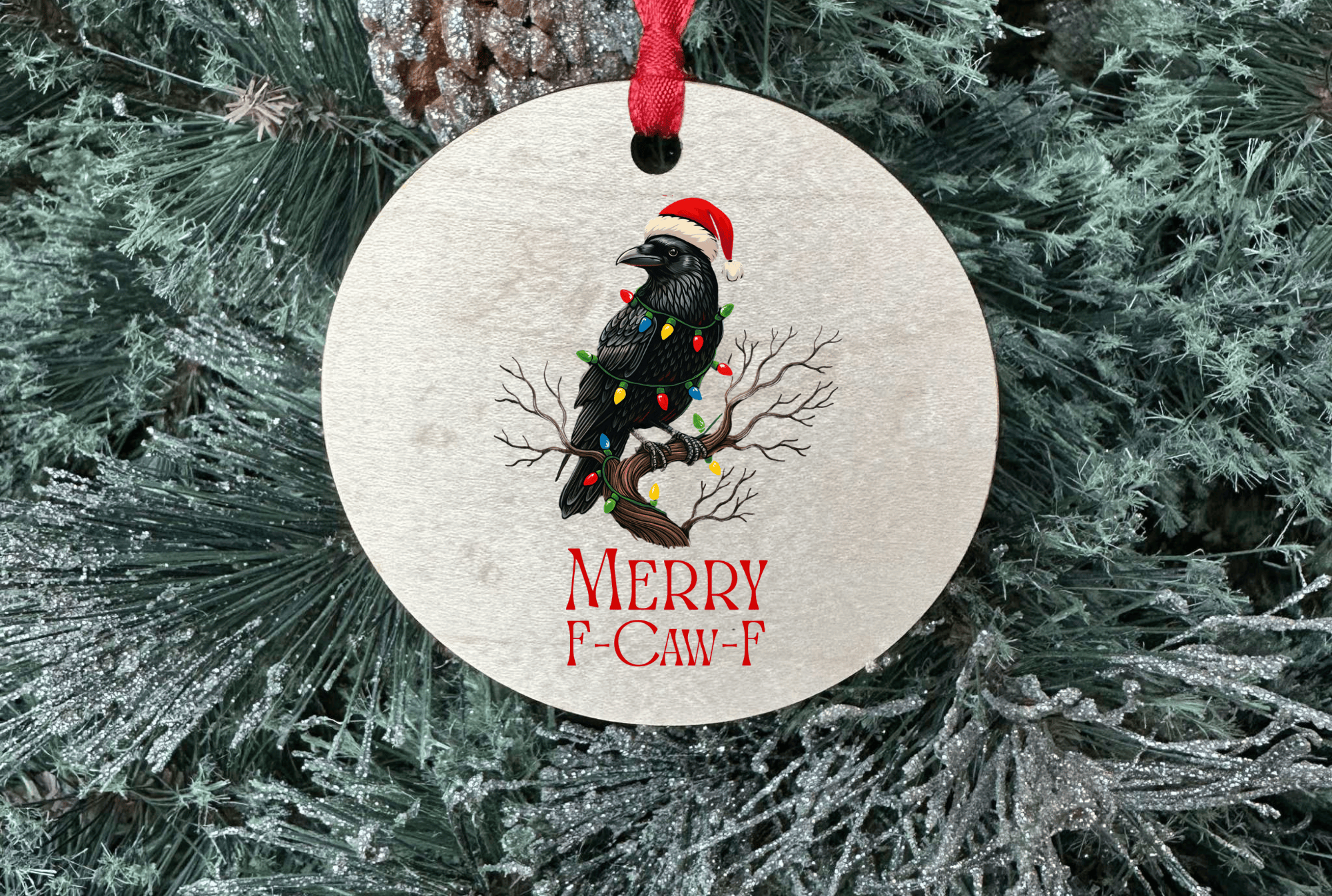 Round Christmas ornament with a bird and lights design on a tree.