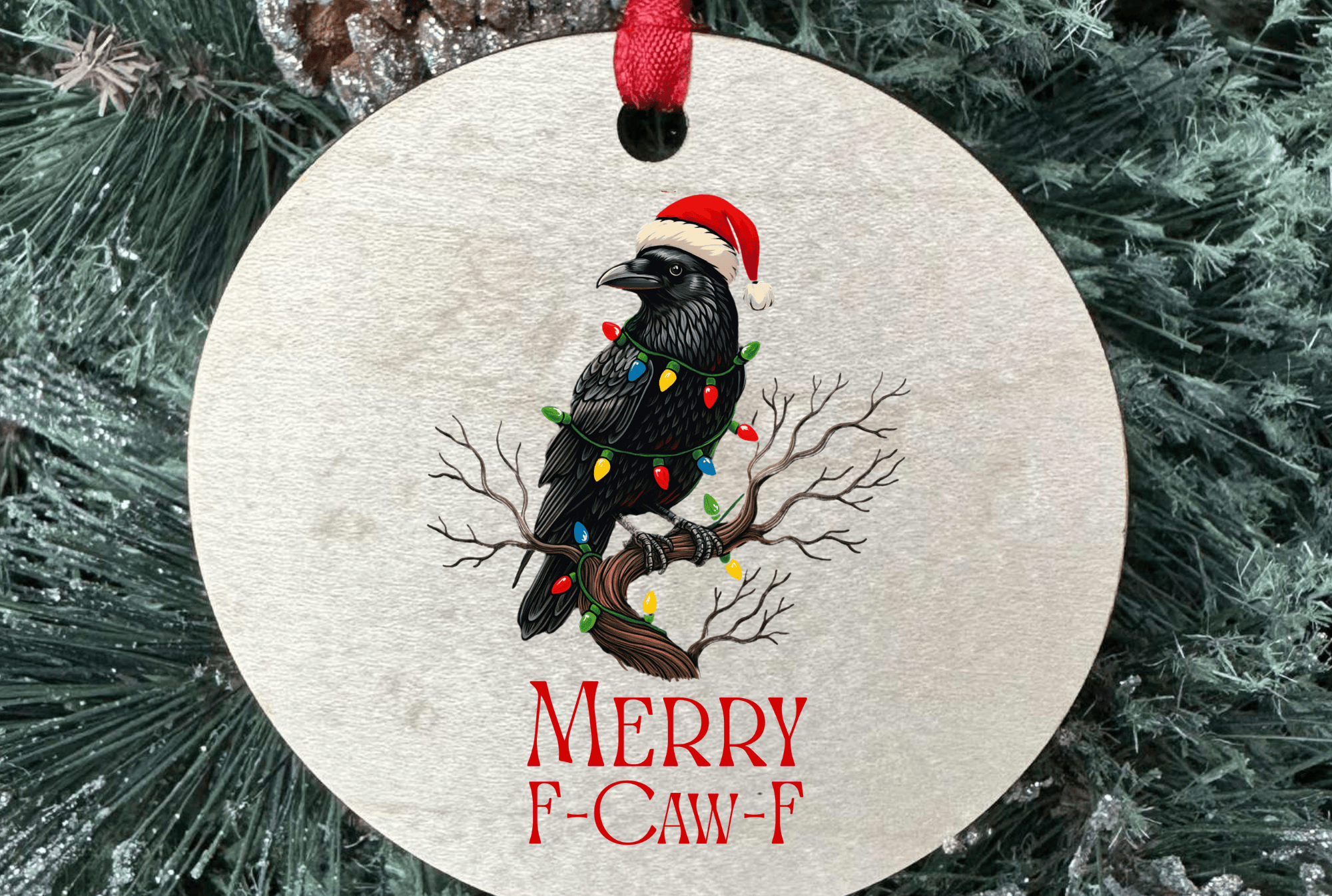 Christmas ornament with a black bird wearing a Santa hat and 'Merry F-Caw-F' text, hanging on a tree.