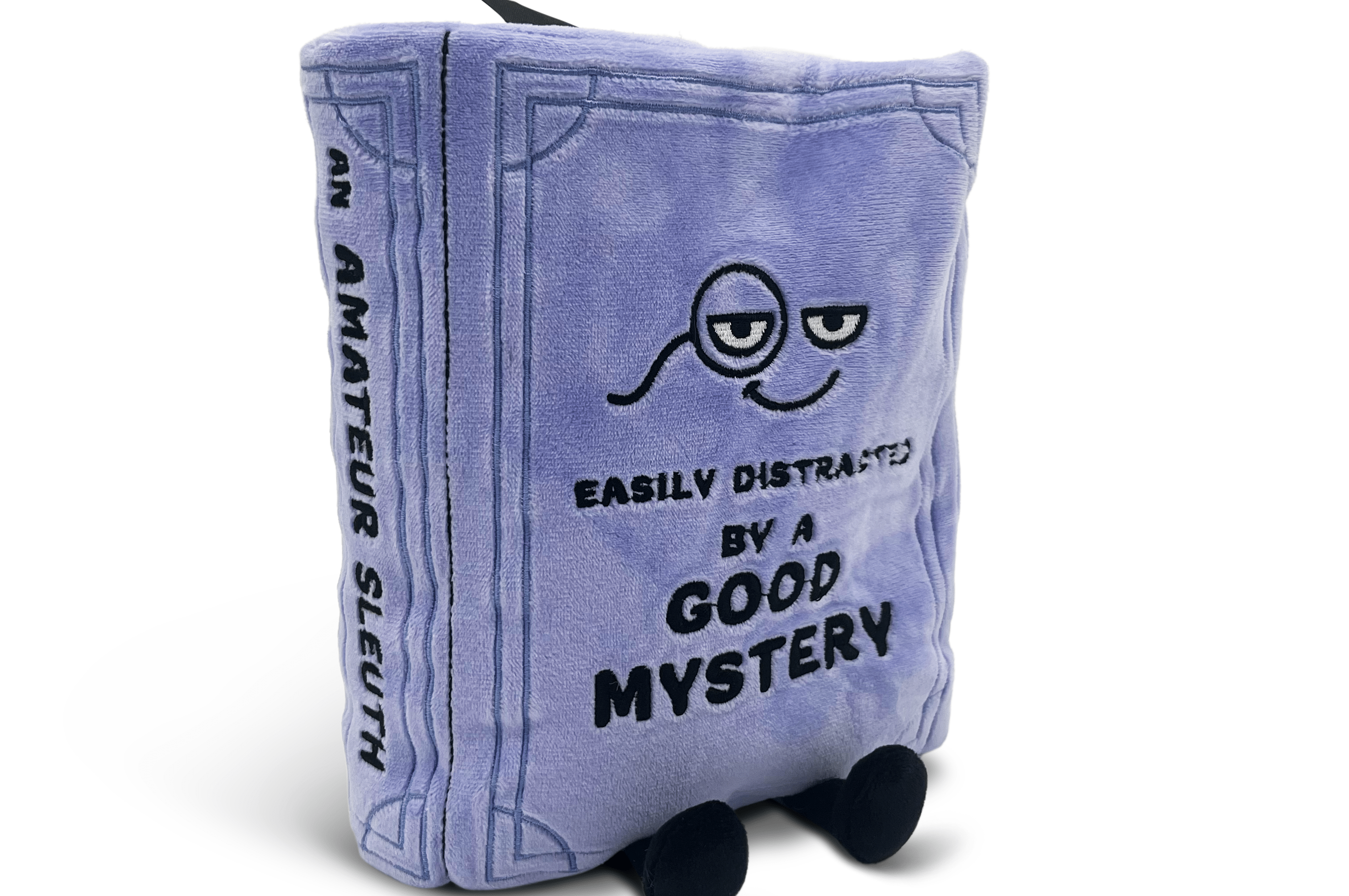 Plush toy shaped like a book with a character design and text on a white background