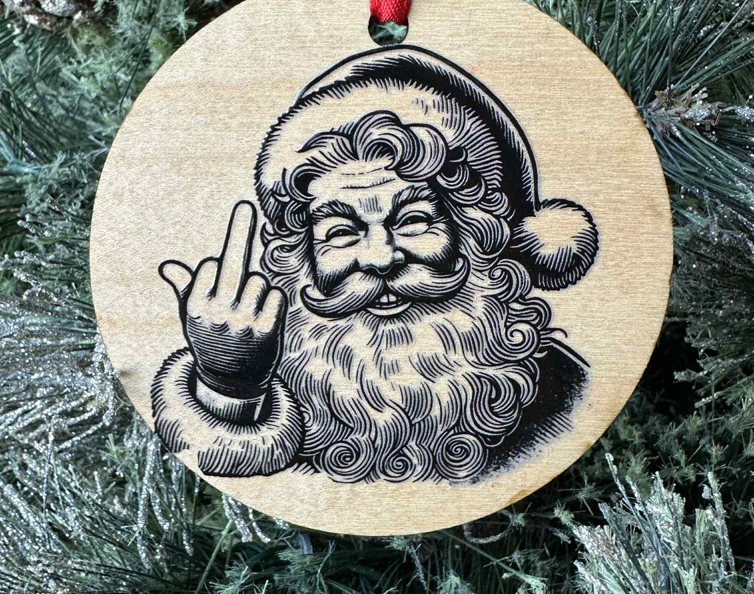 Wooden ornament with a printed design of Santa Claus on a Christmas tree.