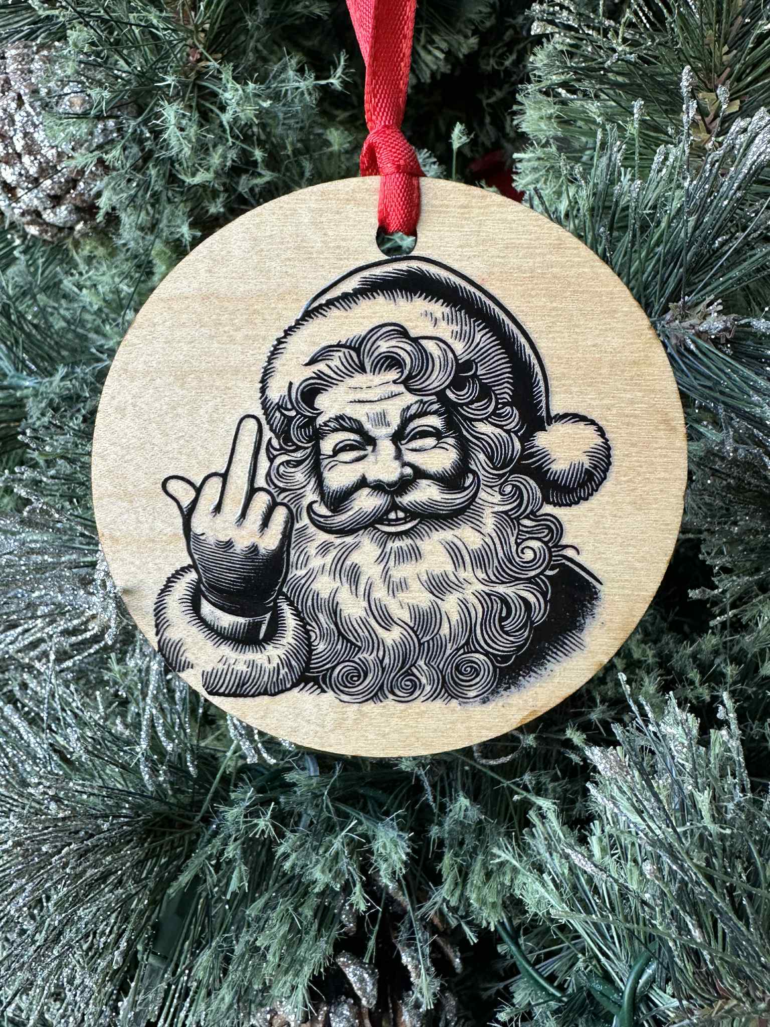 Wooden ornament with a printed design of Santa Claus on a Christmas tree.