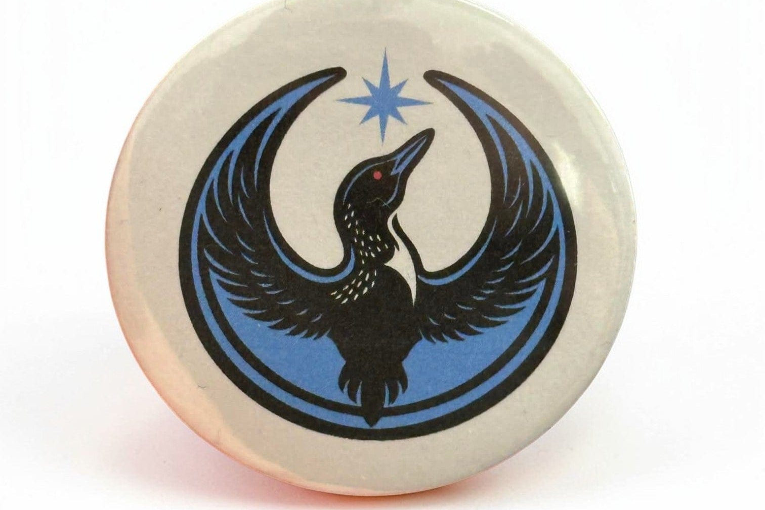 Rebel Loon printed on a white background on a button.