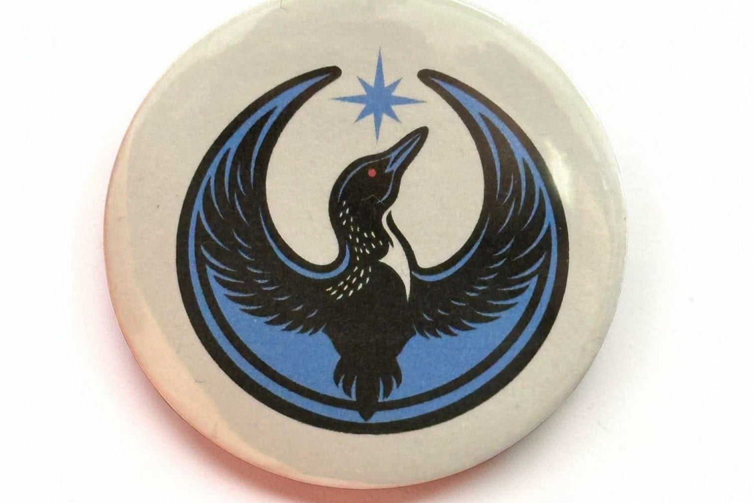 Rebel Loon printed on a white background on a button.