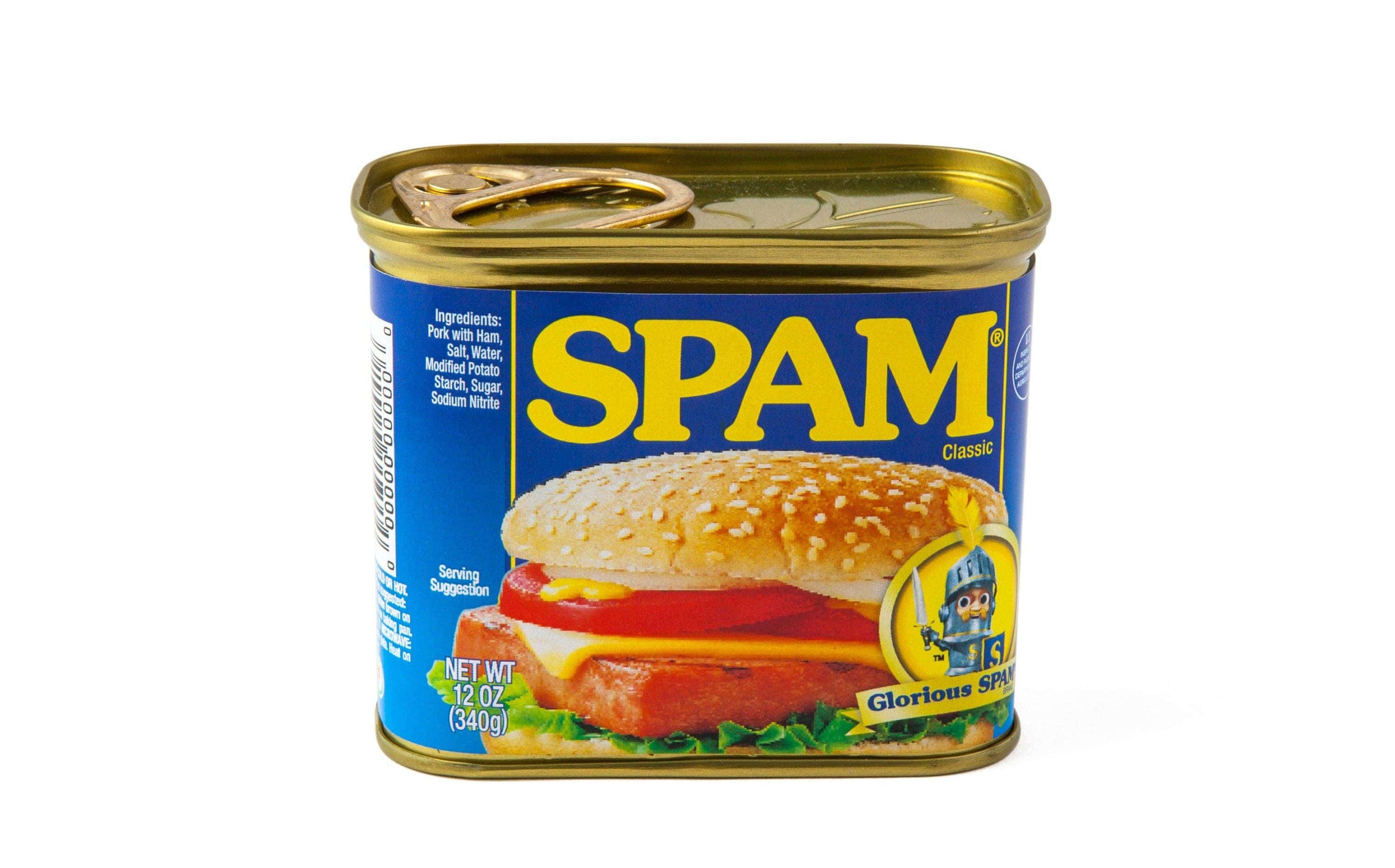A can of Spam Classic with a blue label, featuring a sandwich topped with a sesame seed bun. The Spam text is bold in yellow, evoking a nostalgic feel.