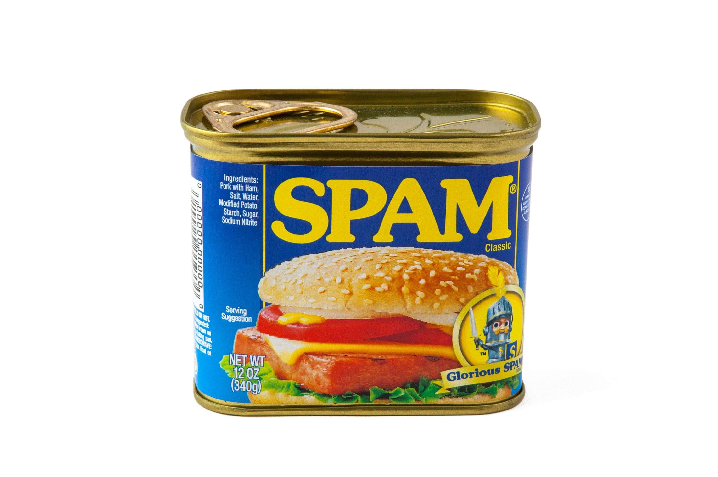 A can of Spam Classic with a blue label, featuring a sandwich topped with a sesame seed bun. The Spam text is bold in yellow, evoking a nostalgic feel.