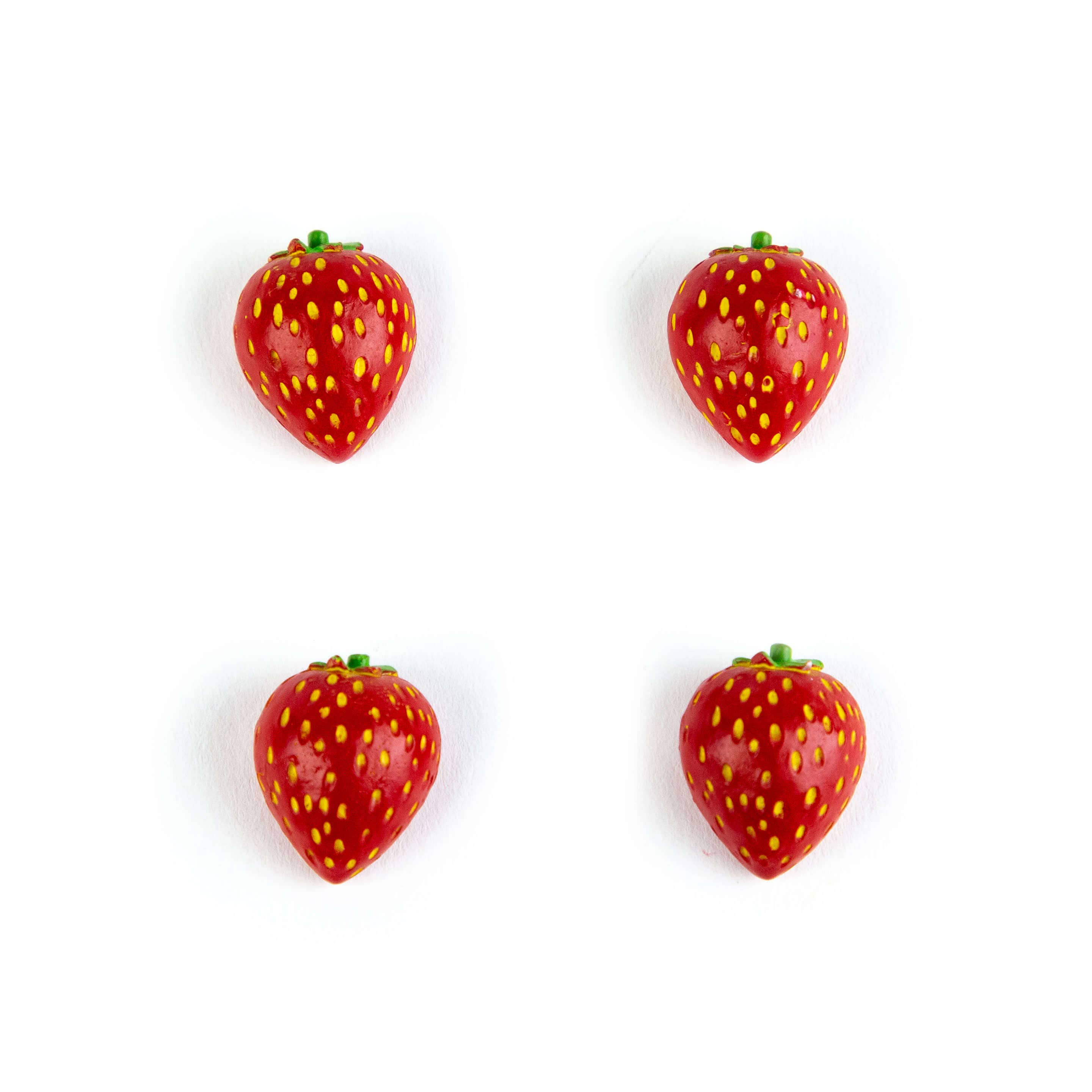 Four red strawberry-shaped objects on a white background