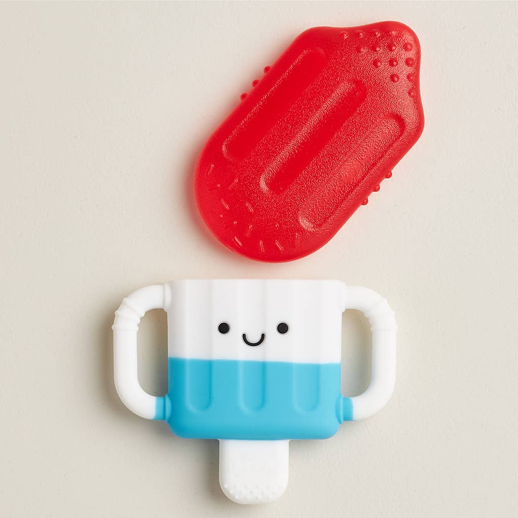 Children's toy resembling a popsicle with a red top and blue handle on a beige background