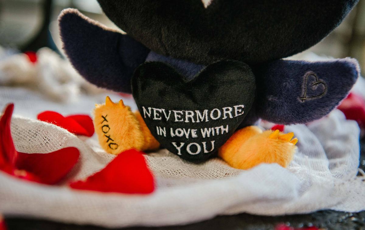 Close up of black heart with "nevermore in love with you" text