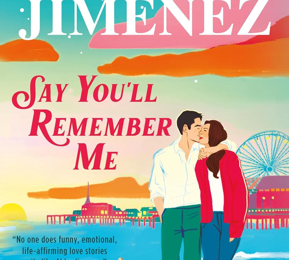 Book cover of 'Say You'll Remember Me' by Abby Jimenez with a couple and dog at a beach.