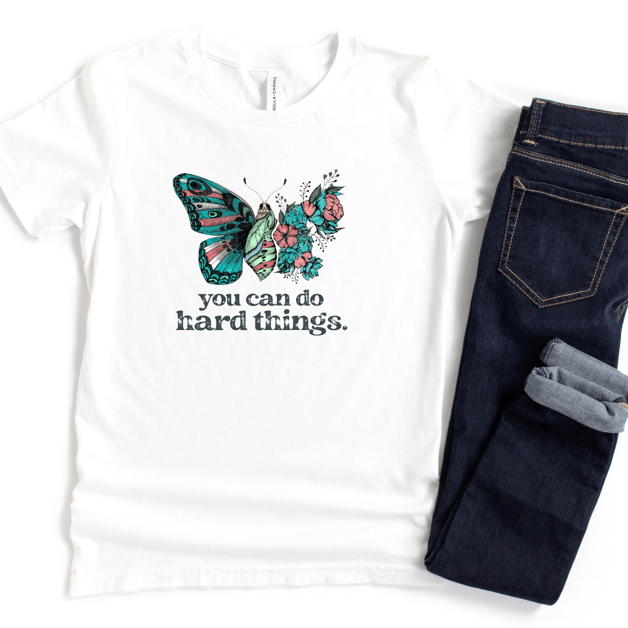 This design shows a beautiful teal and pink butterfly as it is changing from a caterpillar. You can do hard things.