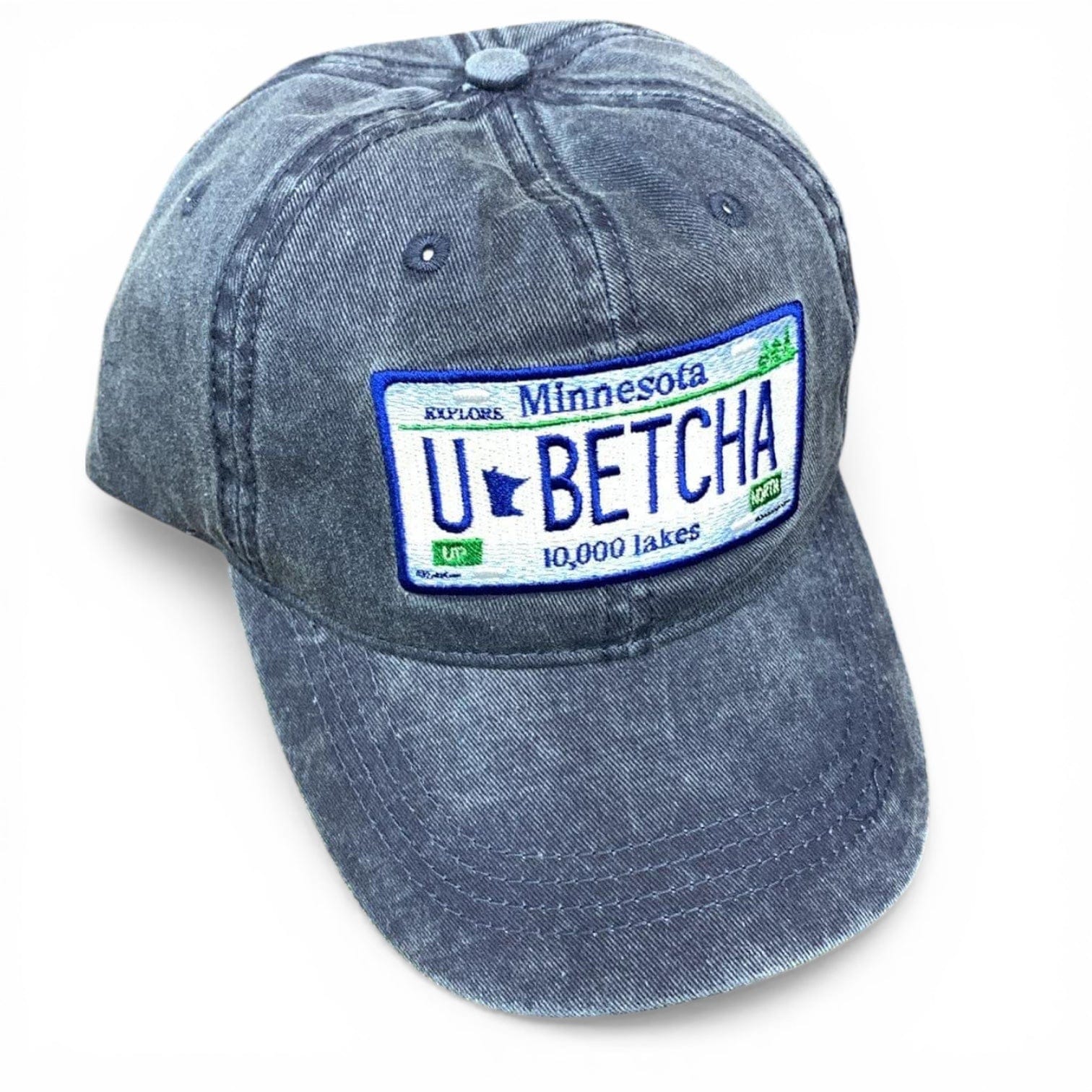 Blue denim cap with a Minnesota-themed license plate design that states “u betcha!” on a white background