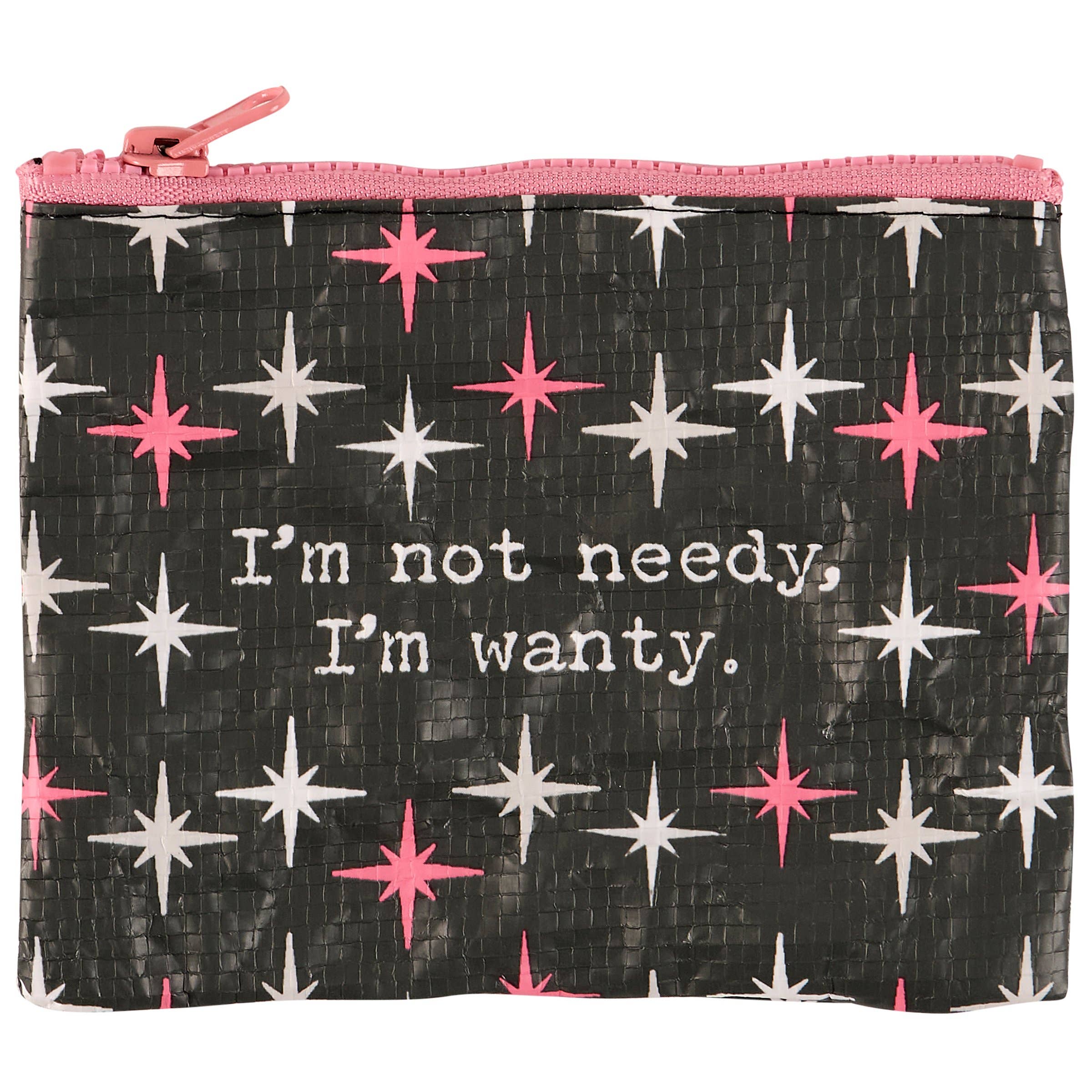 A zippered pouch with a pink top edge patterned with pink and white stars on a black background. It reads, "I'm not needy, I'm wanty." The tone is playful.