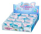 Display of "Axolotl Kiji Buddy & Slime" toys in a blue box. Each container has a cute pink axolotl in clear slime. Packaging is colorful and playful.