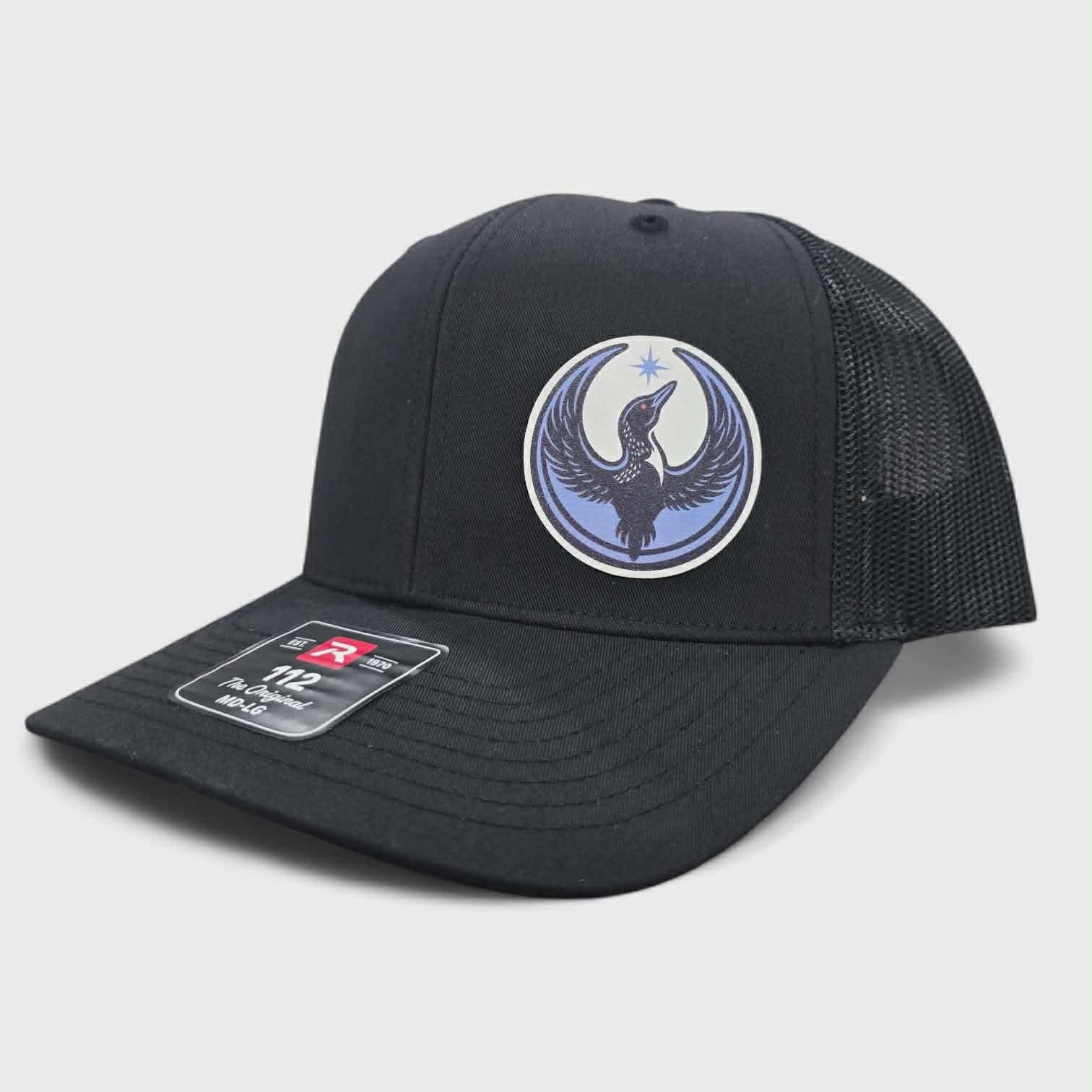 Black cap with a rebel loon logo on a light gray background