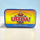 Mint tin with colorful label featuring cartoon character and text “U Betcha!” on a white background
