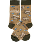Brown socks with green cuffs and toes, featuring a mushroom pattern and blue dots. Text reads, "I'd rather be foraging," conveying a playful, earthy theme.