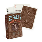 Box of novelty playing cards titled "52 Farts," with two cards fanned out, displaying humorous fart definitions. The tone is playful and lighthearted.