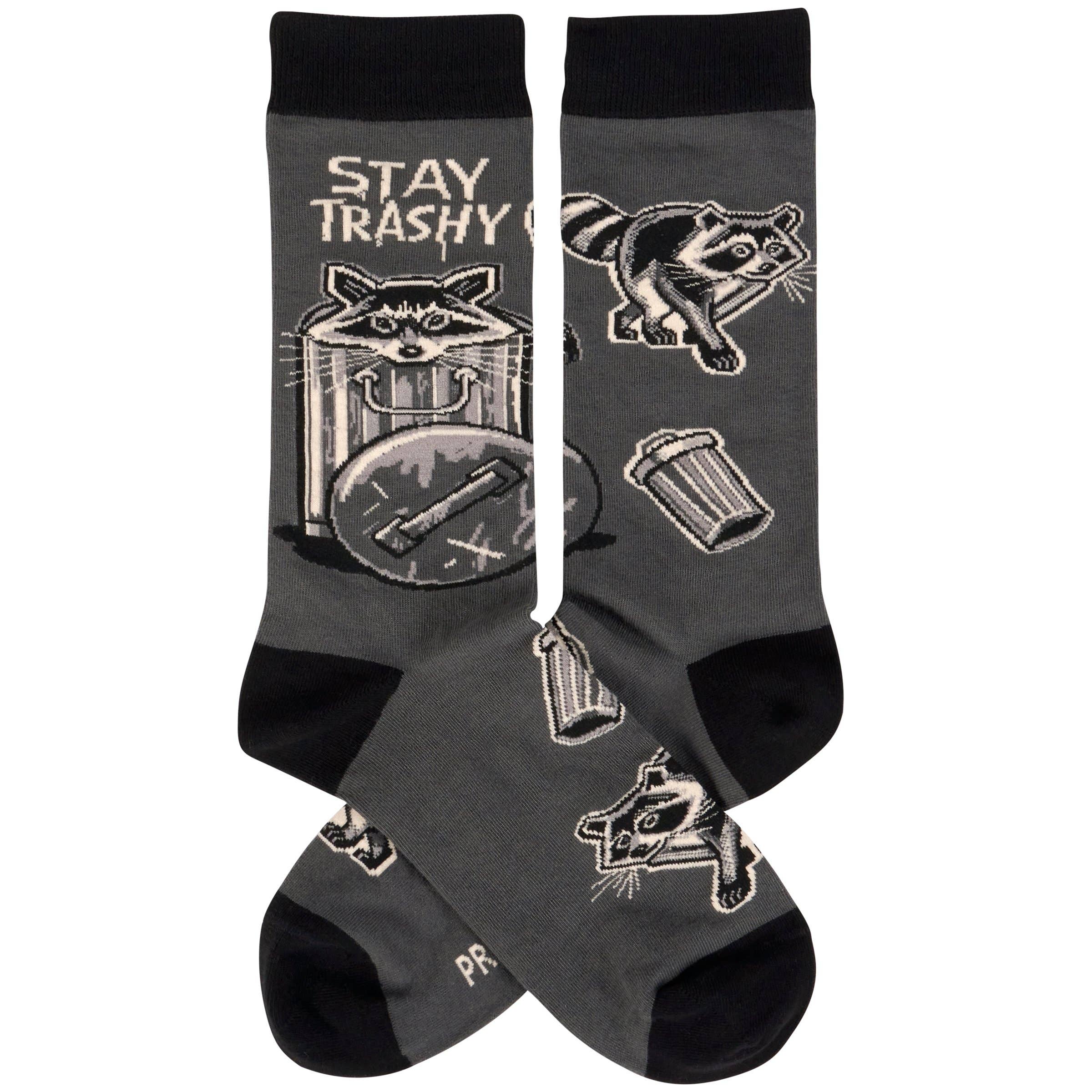 Black socks with raccoon illustrations and 'Stay Trashy' text on a white background