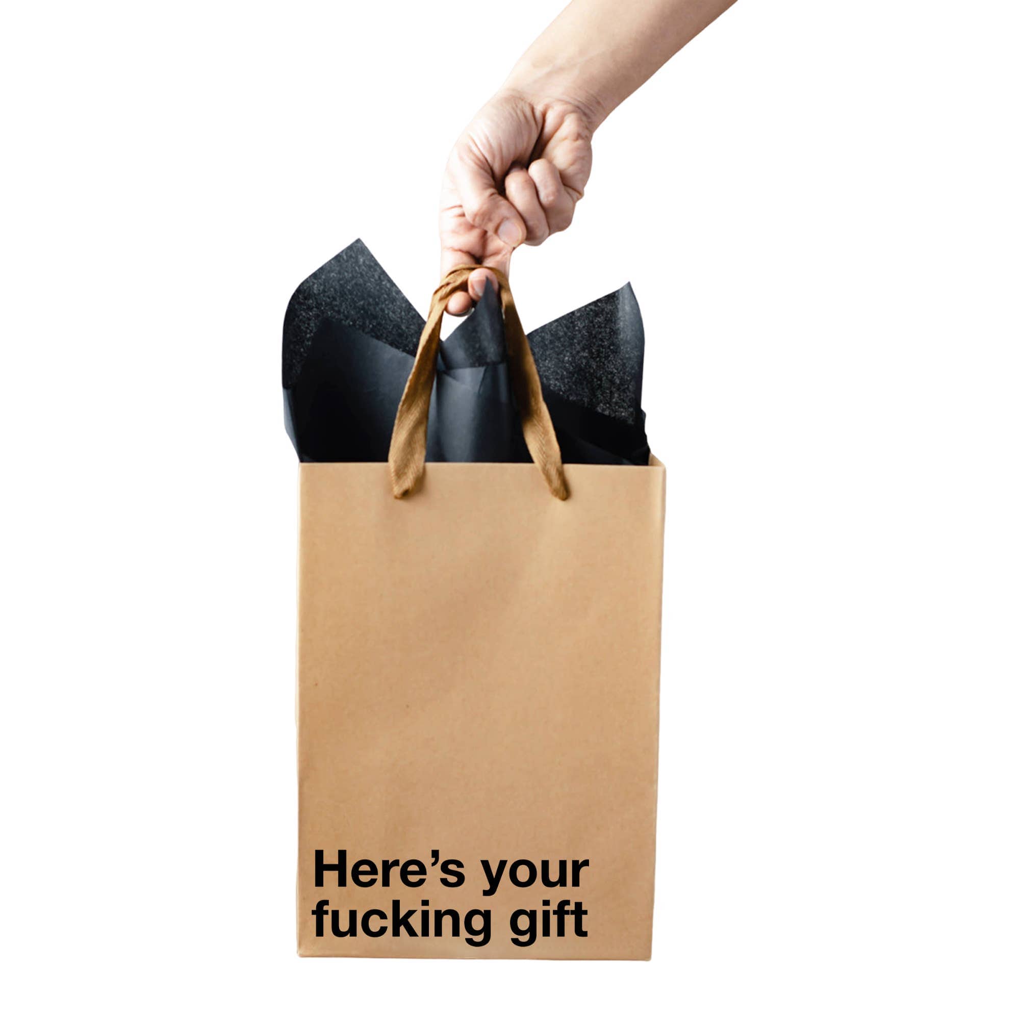Hand holding a brown gift bag with black interior, containing a black item, on a white background.