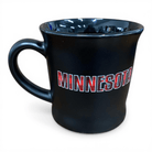Black mug with 'MINNESOTA' printed in buffalo plaid on it against a white background
