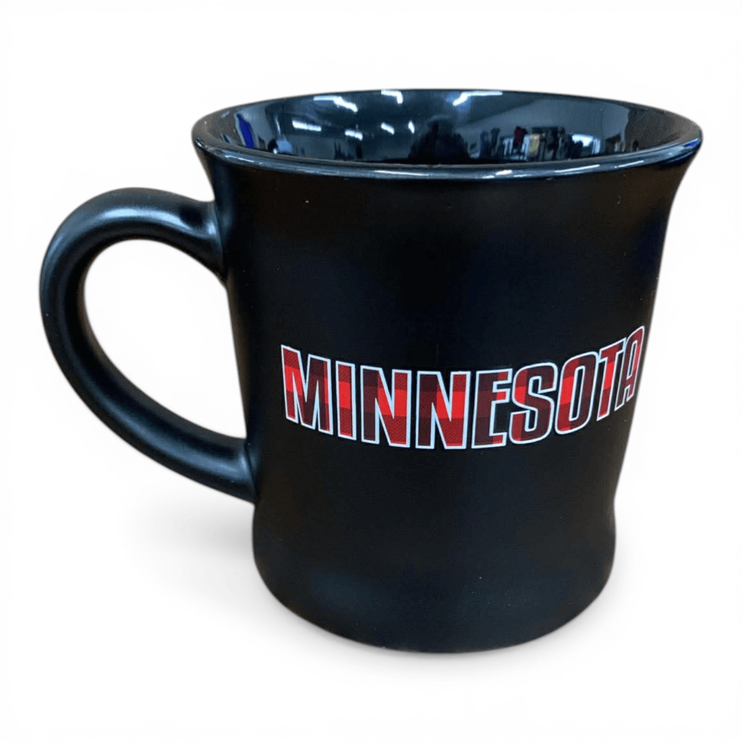Black mug with 'MINNESOTA' printed in buffalo plaid on it against a white background