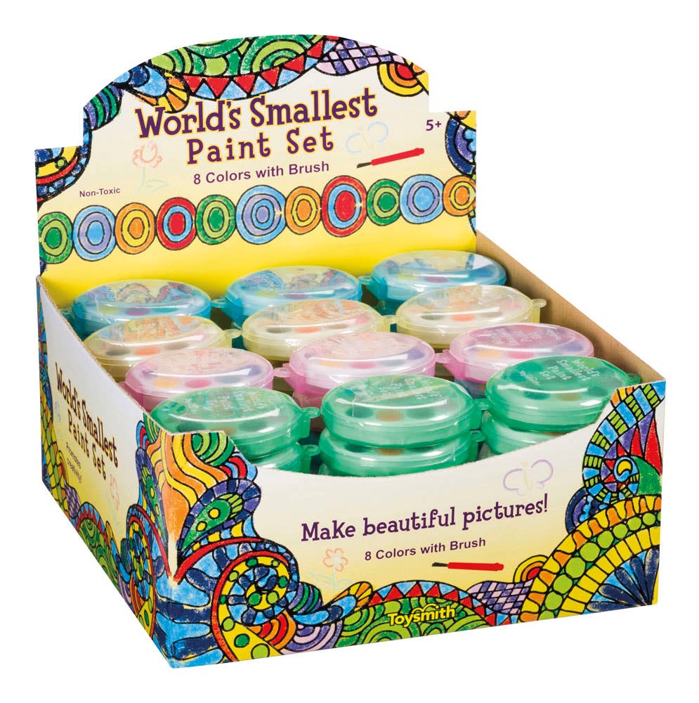 A display box labeled "World's Smallest Paint Set" holds eight mini paint sets with pastel lids. The box features colorful, intricate, swirly designs.