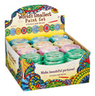 A display box labeled "World's Smallest Paint Set" holds eight mini paint sets with pastel lids. The box features colorful, intricate, swirly designs.