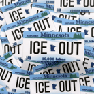 Stack of 'ICE OUT' Minnesota license plates with text about lakes.