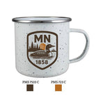 White speckled enamel mug with a brown loon's image, pine trees, setting sun, and "MN 1858" text. Calm, vintage outdoor theme.